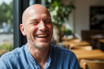 Bald man laughing